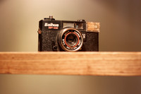 A Black Old Camera on a Shelf