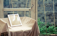 A Frame in a Chair and a Glass Door